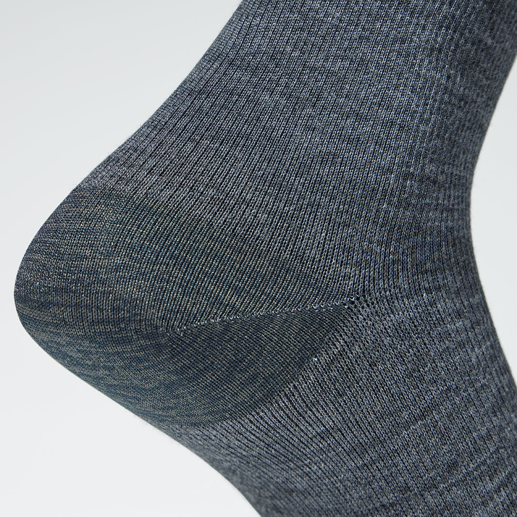 Detailed view of a short grey compression sock with pink details.