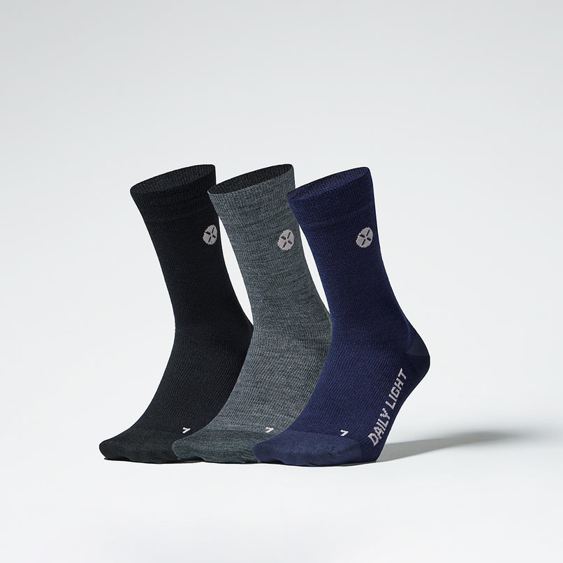 Front view of three multi colored mid-calf compression socks.