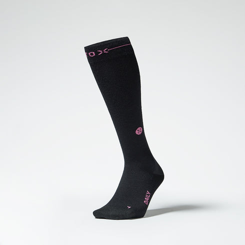 Front view of a black knee high compression sock with fuchsia details.