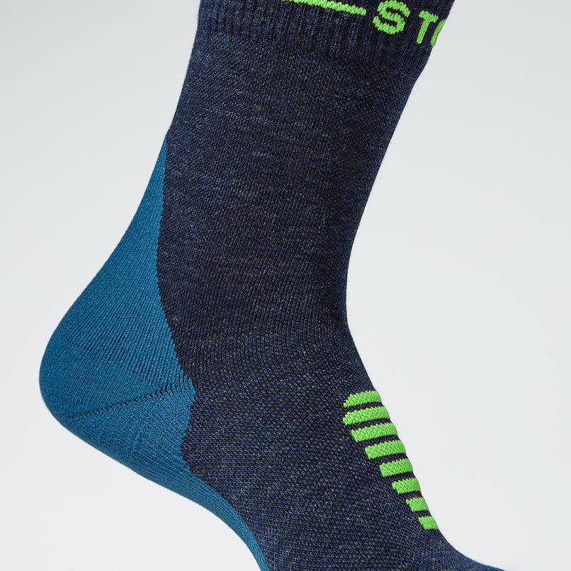 Detailed view of dark blue ankle compression socks with green details. 
