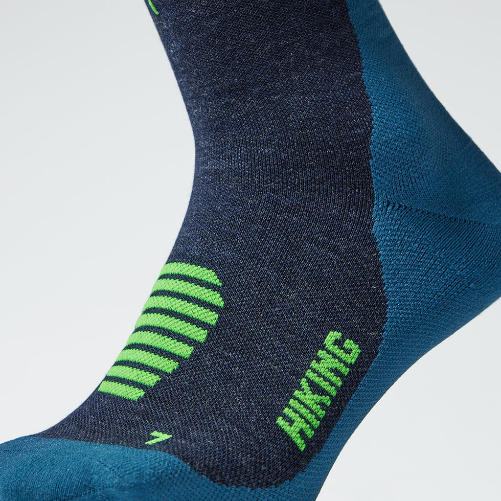Close up of a dark blue compression sock with green text. 