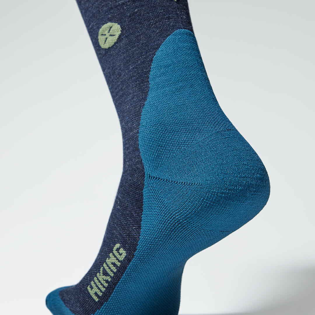 Close up of a dark blue compression sock with a lighter blue heel.
