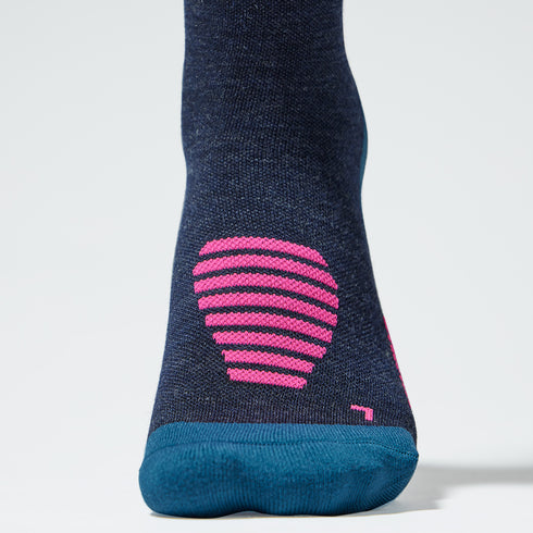 Close up of a dark blue compression sock with pink text.