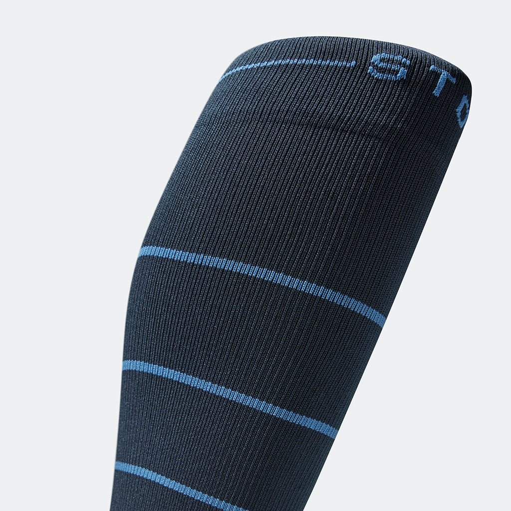 Detailed view of a blue knee high compression sock with blue details.