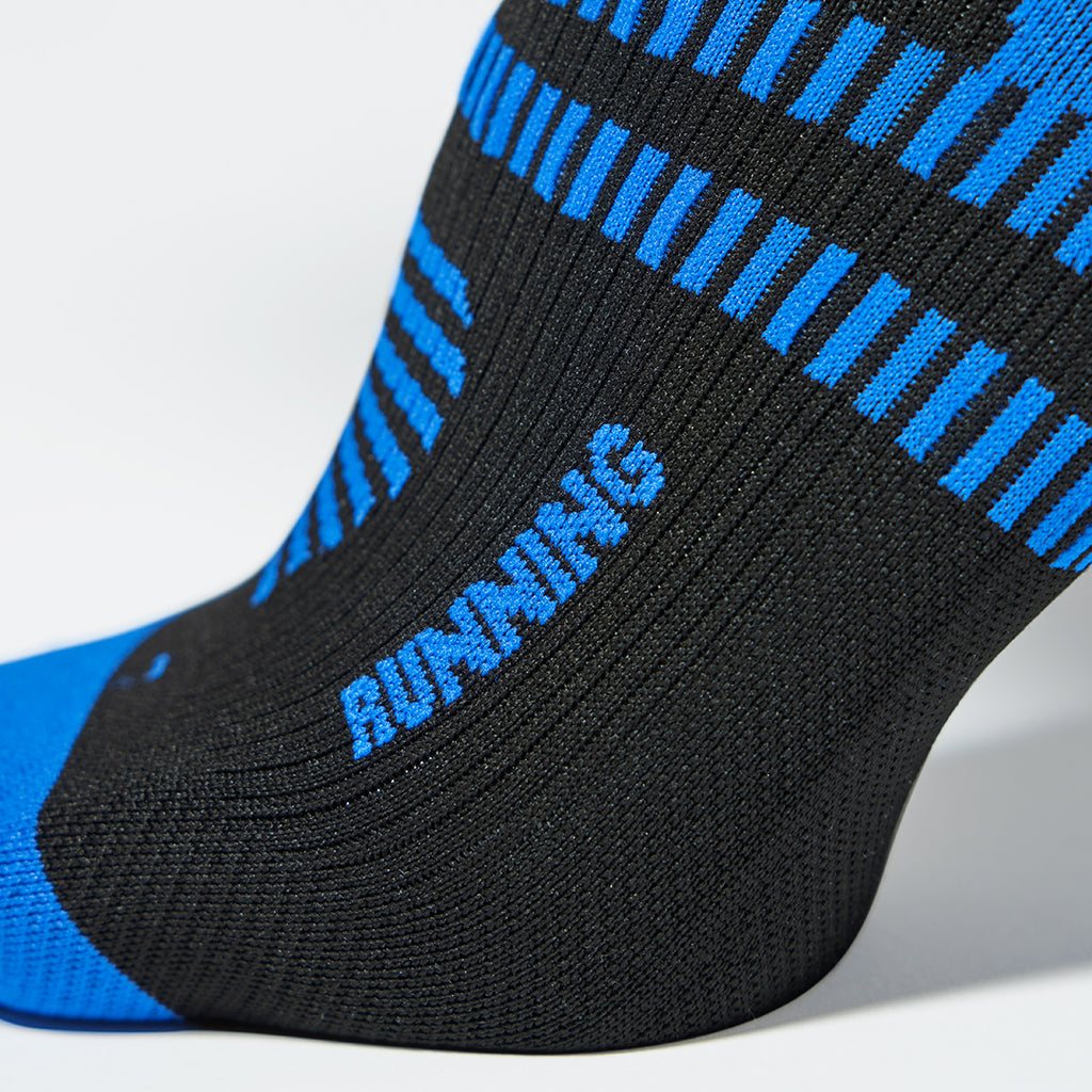 Close up of a black compression sock with blue text.