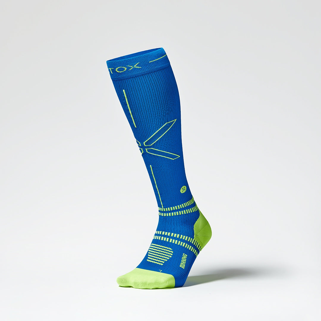 Front view of a high compression sock in blue with yellow accents.