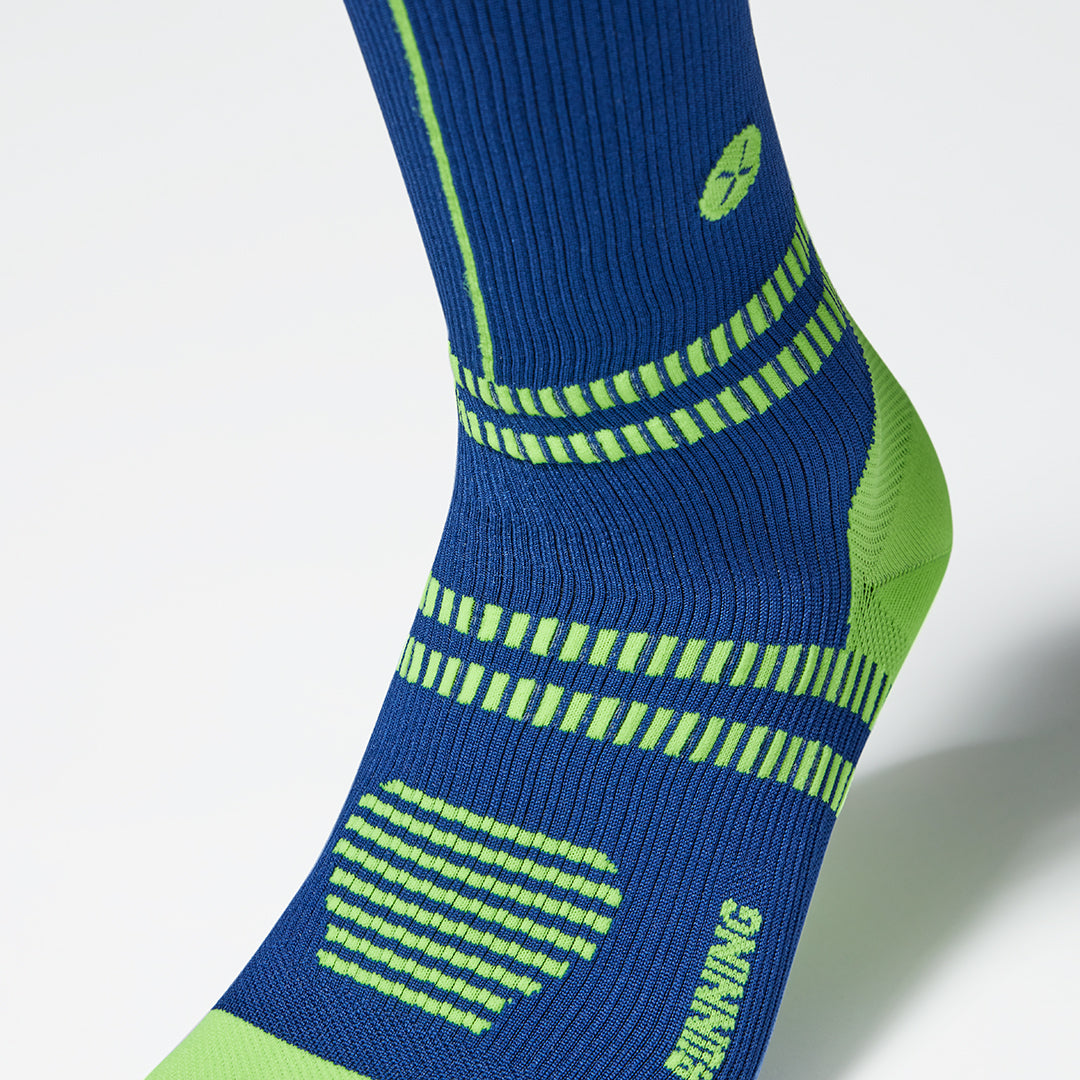 Zoomed in picture of the front a dark blue compression sock.  
