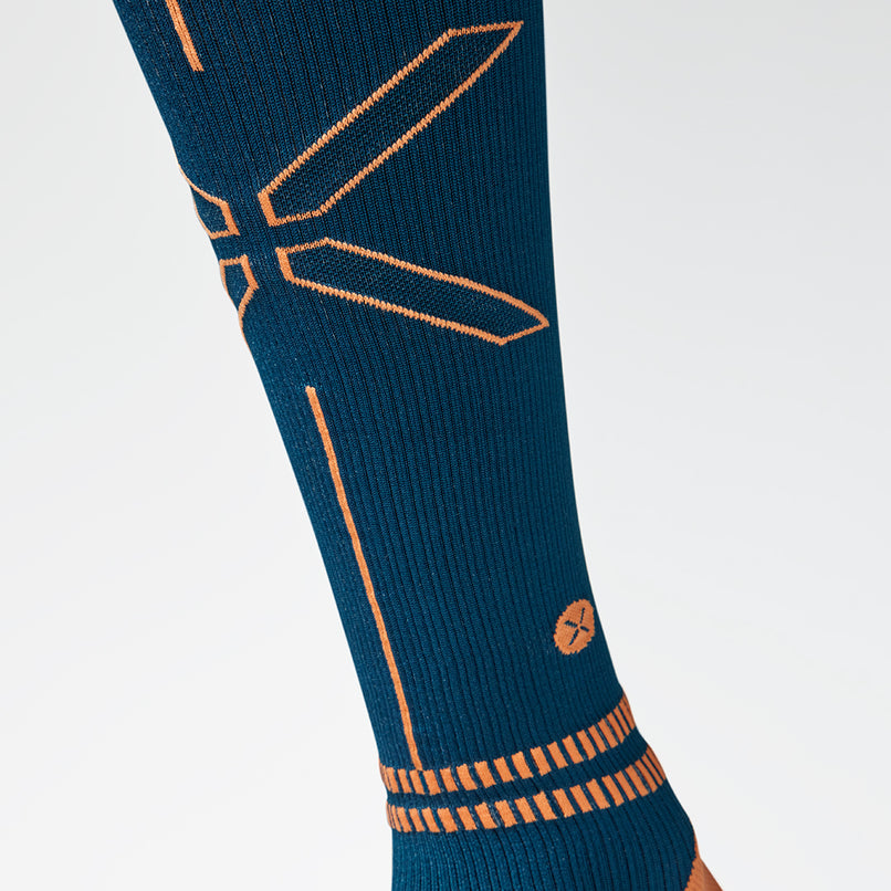Close up picture of regatta blue sock with orange details.