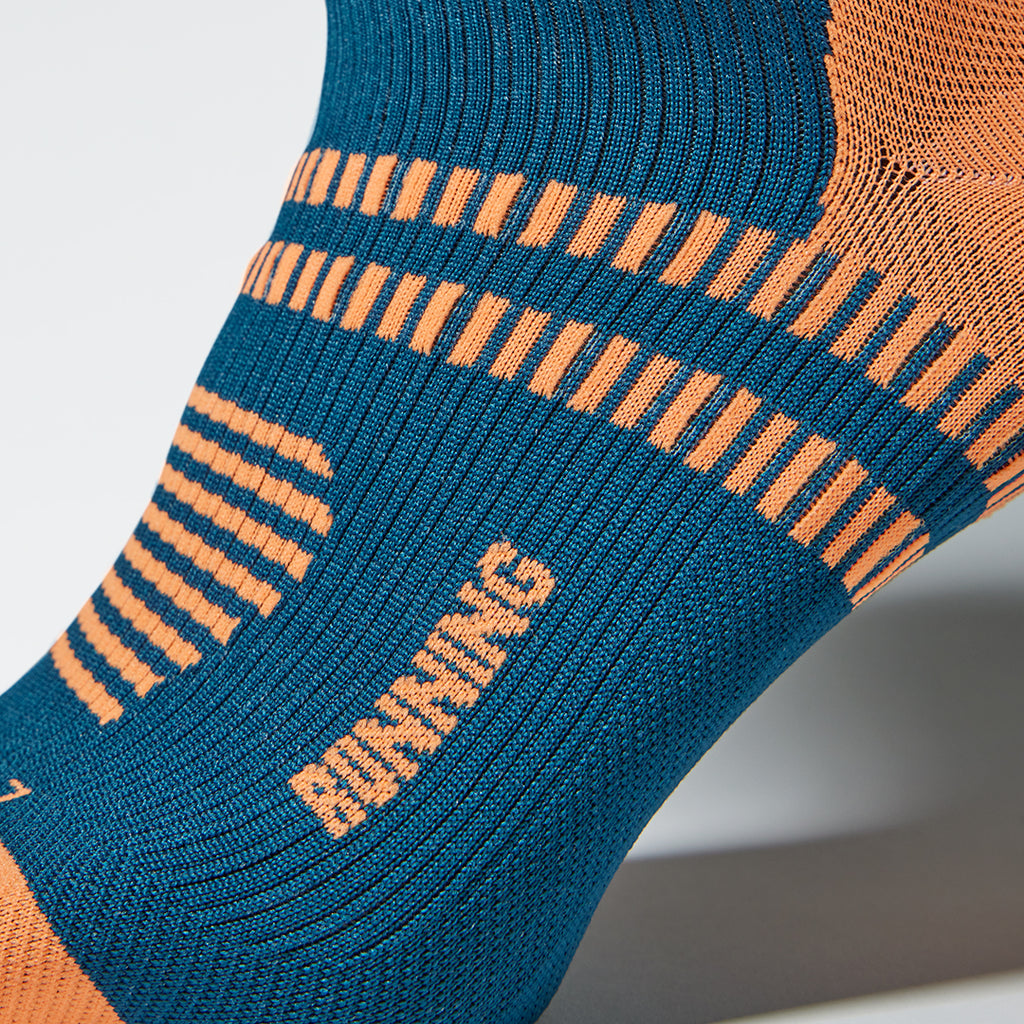Close up of a regatta blue sock with orange text.