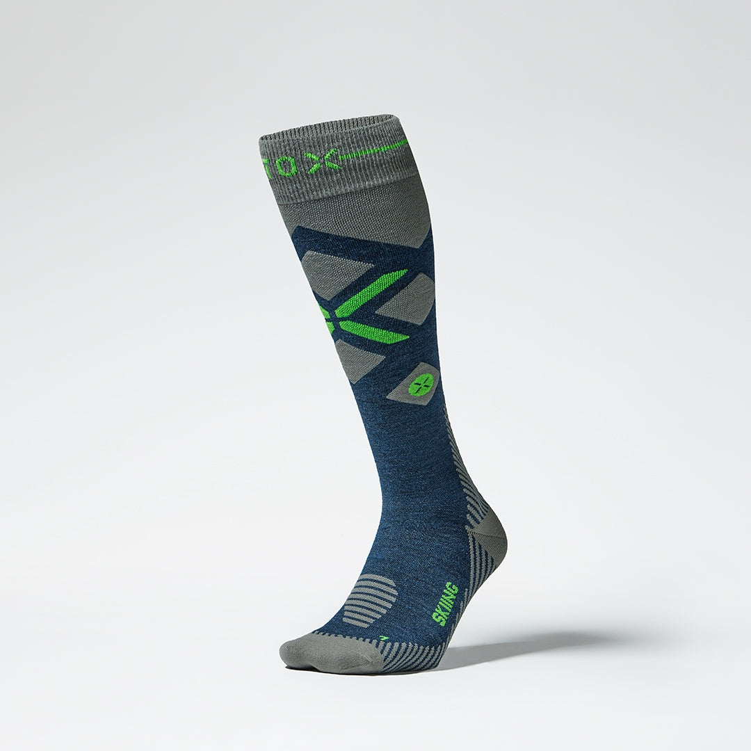 Front view of grey blue compression socks with green details.