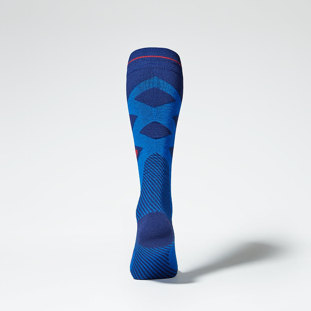 Back view of blue compression socks with red details.