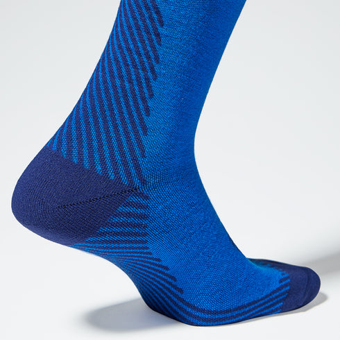 Close up of a cobalt high compression sock with a blue heel.