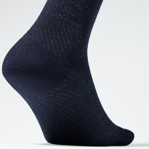 Close up of a navy knee high compression sock.