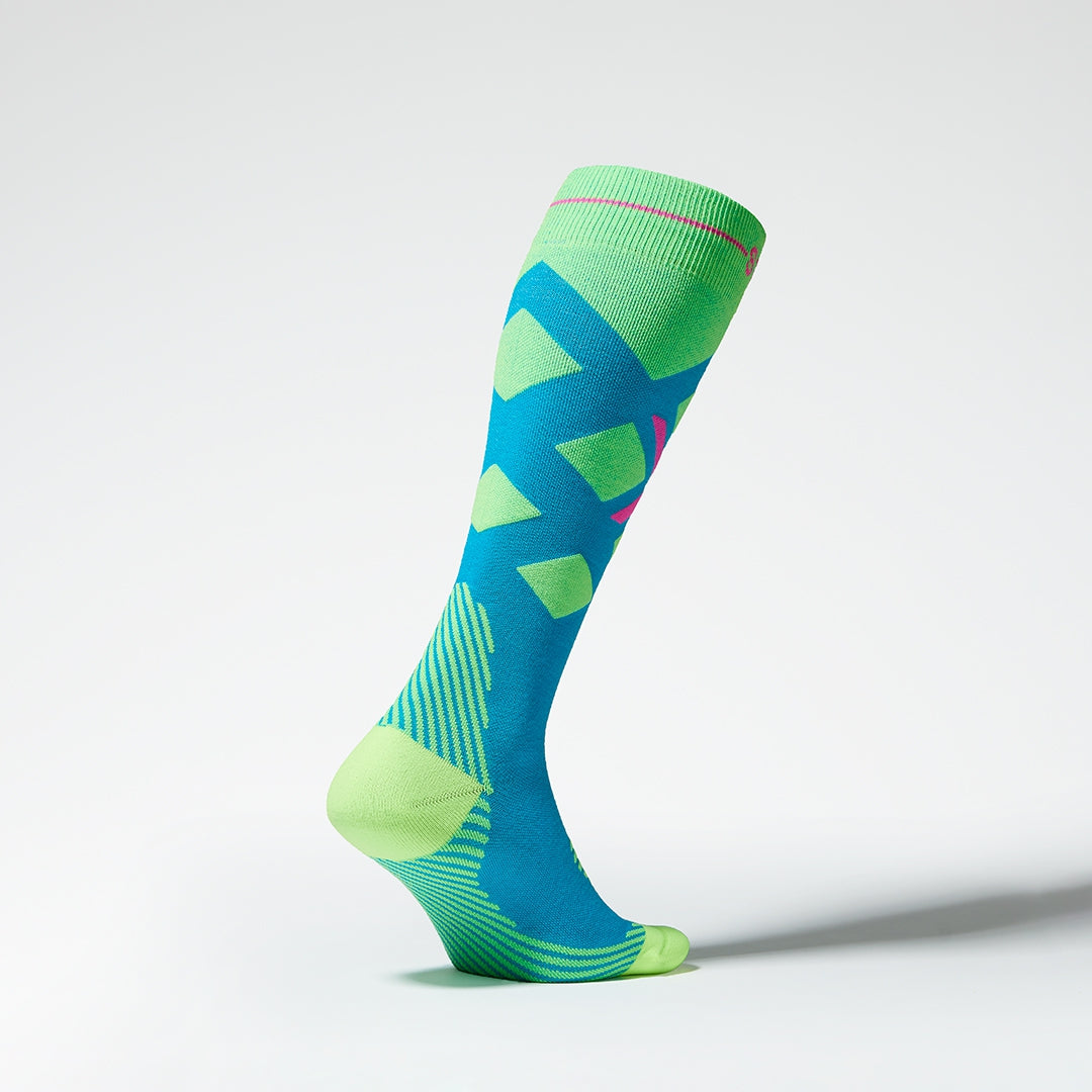Side view of blue and yellow compression socks with pink details.