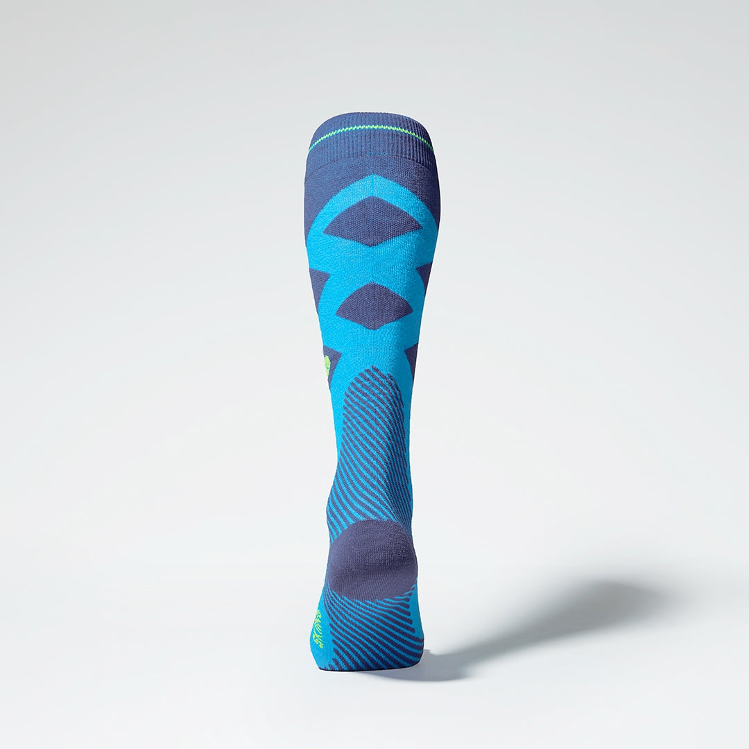 Back view of turquoise compression socks with yellow details.