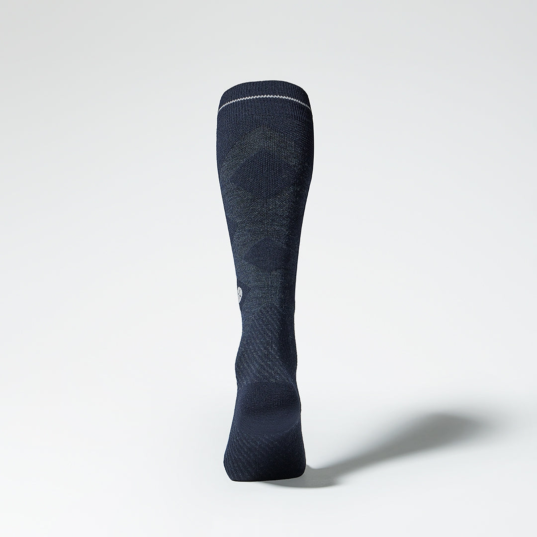 Back view of a navy compression skiing socks with pink details.