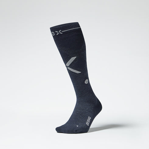 Front view of a navy compression skiing socks with pink details.