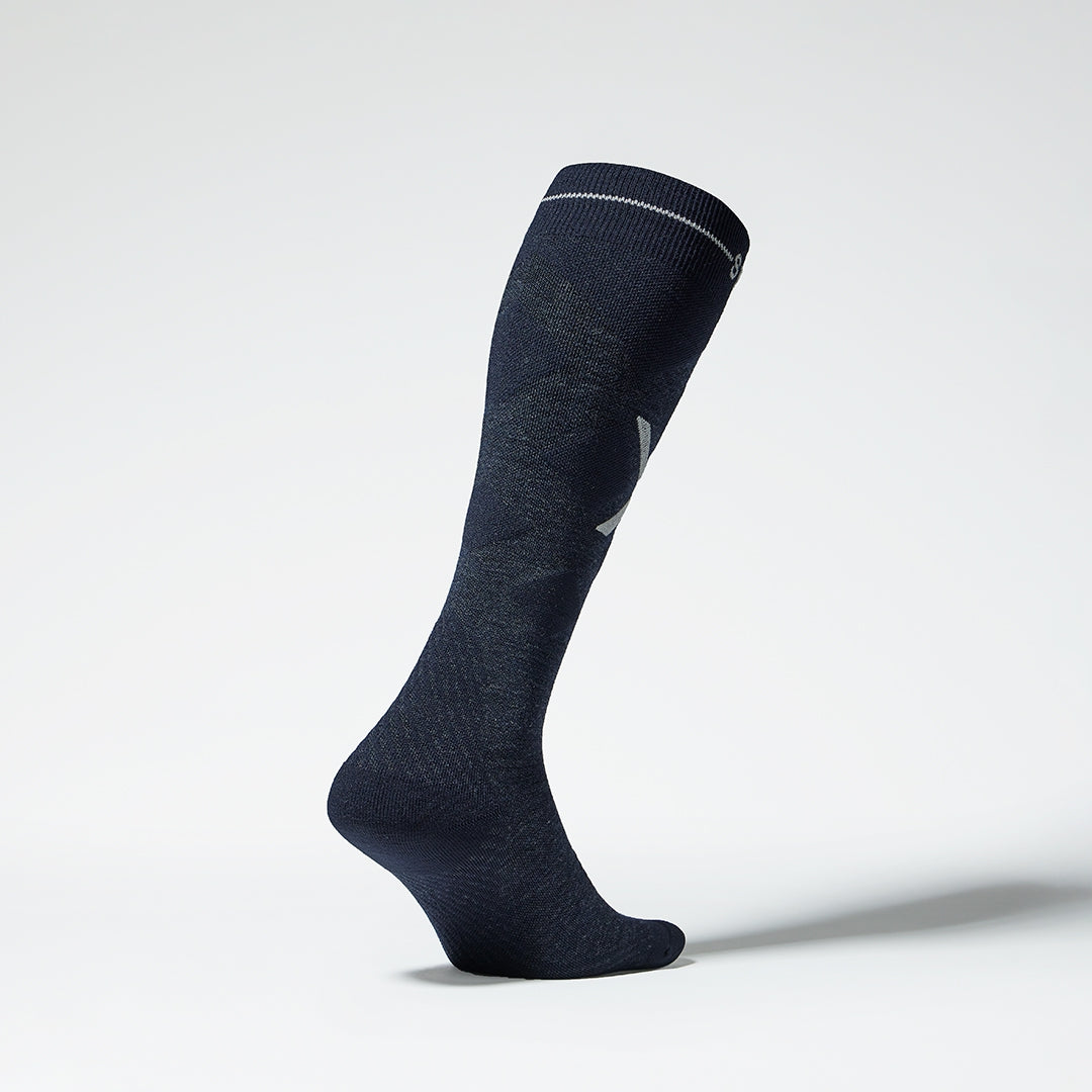 Side view of a navy compression skiing socks with pink details.