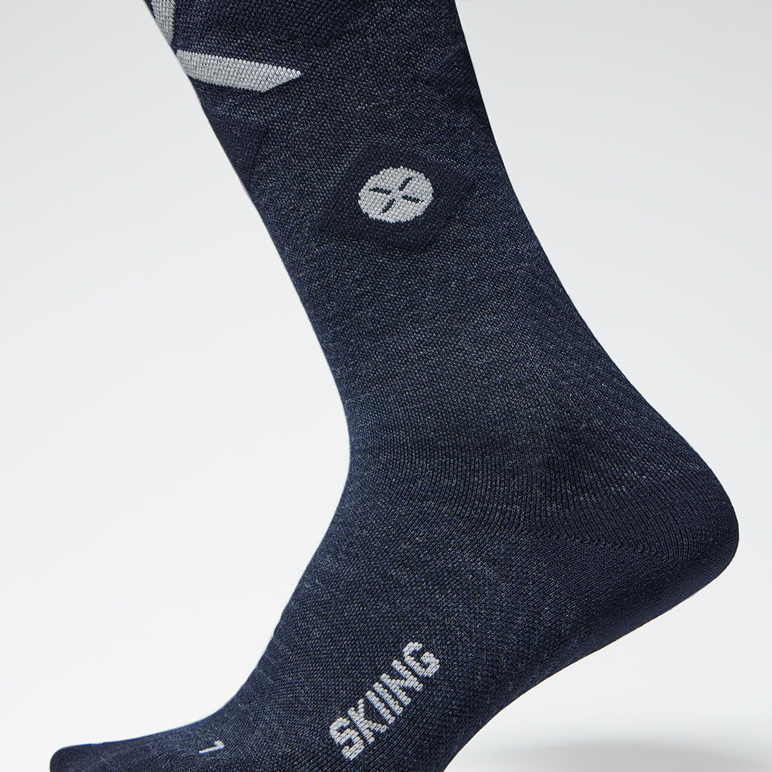 Close up of a navy compression sock with a small grey logo.