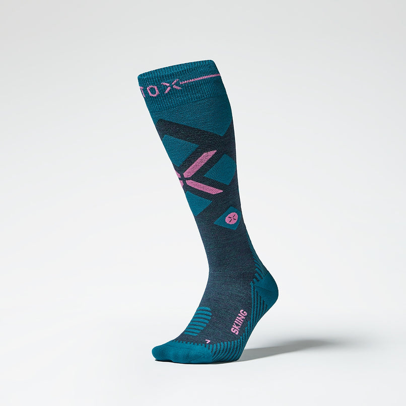 Front view of a teal compression skiing socks with pink details.