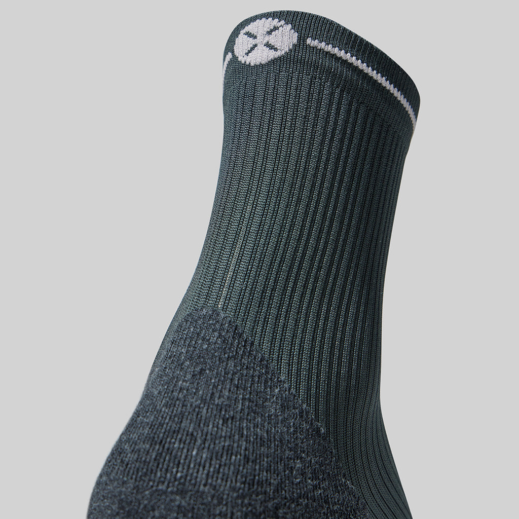 Grey compression sock with light grey logo. 