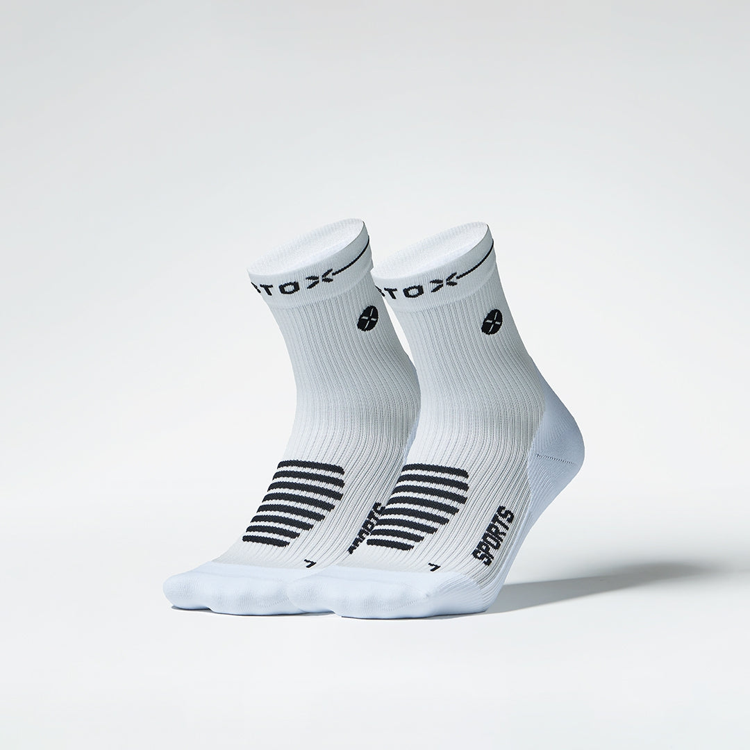 Two left pairs of white sports ankle socks next to each other.