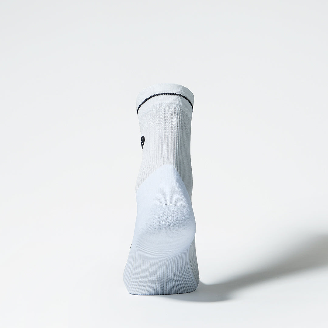Back view of a white sports ankle sock. 