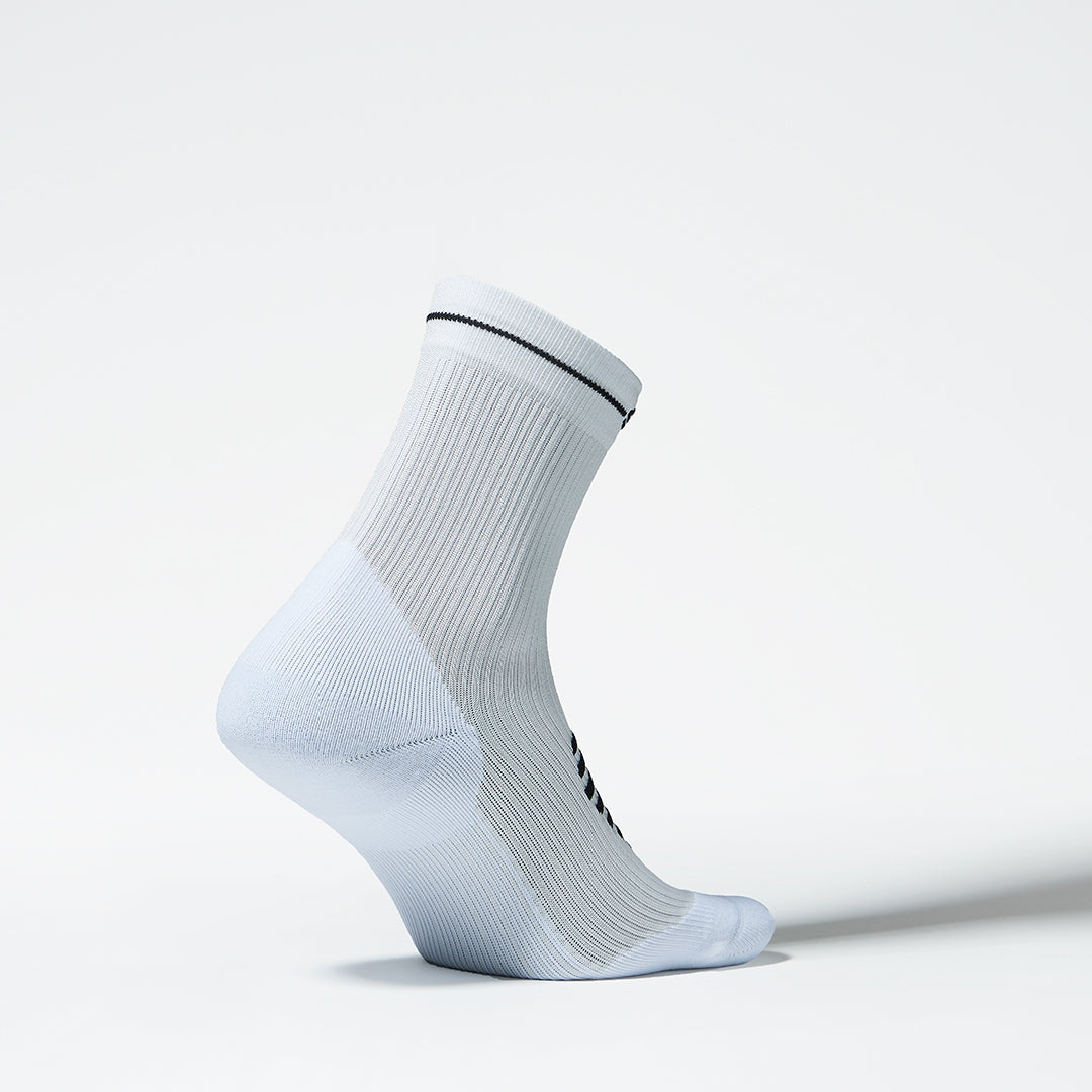 Side view of a white sports ankle sock.