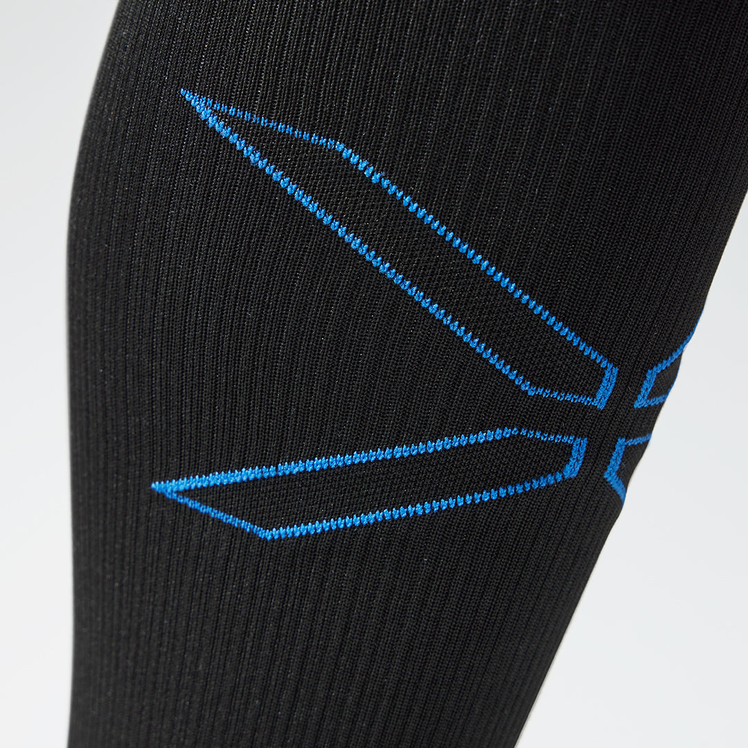 Detailed view of a black compression calf sleeve with blue details.
