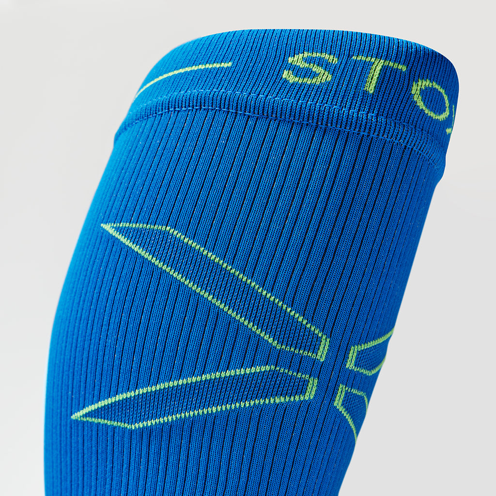 Detailed view of a blue compression calf sleeve with yellow details.
