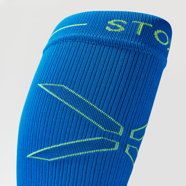 Detailed view of a blue compression calf sleeve with yellow details.