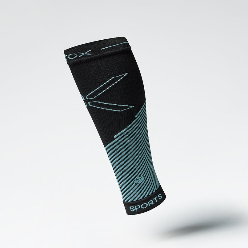 Front view of a black compression calf sleeve with blue details. 