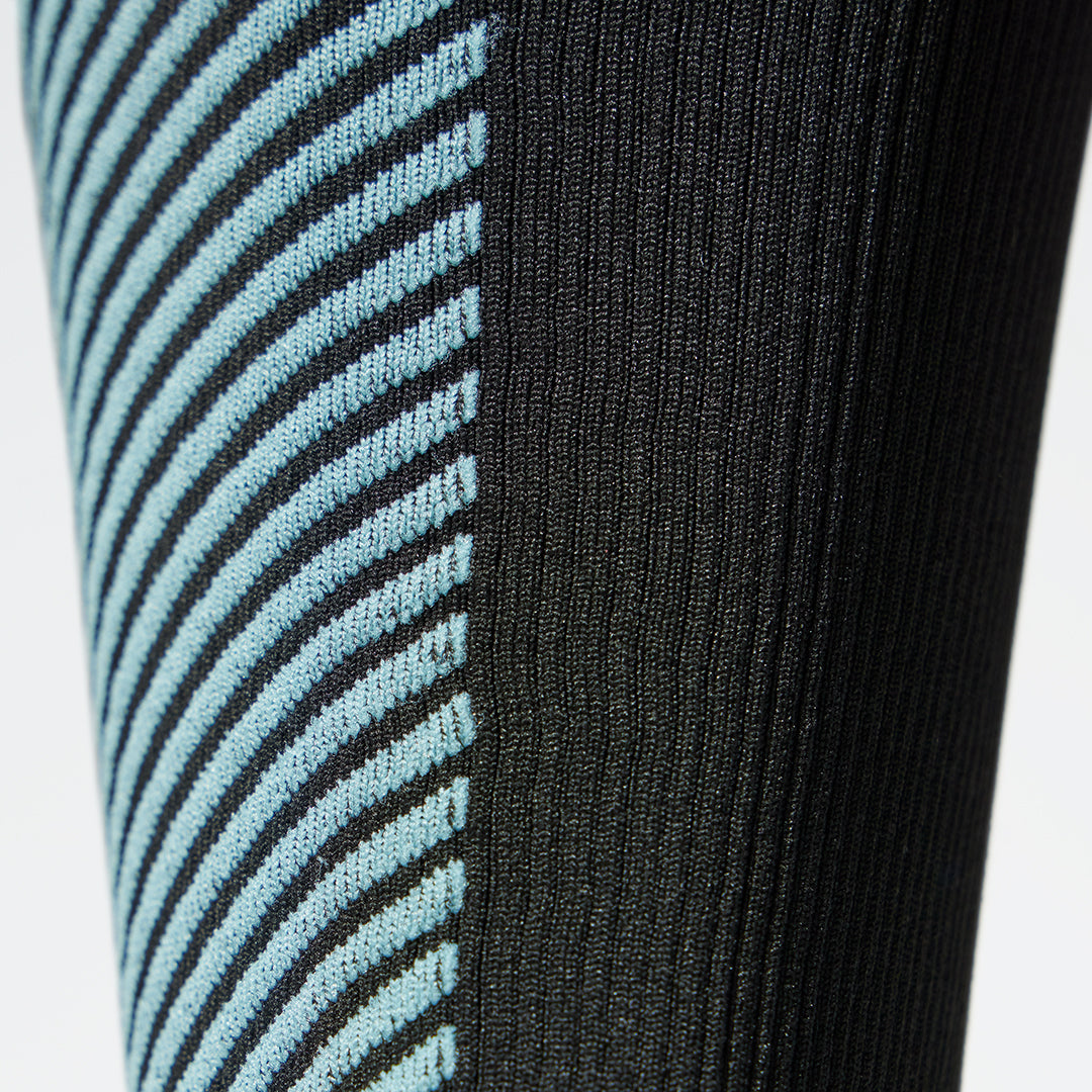 Detailed view of a black compression calf sleeve with light blue details. 