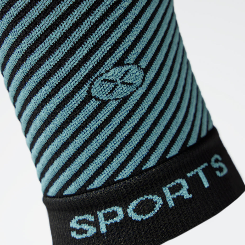 Detailed view of a black compression calf sleeve with light blue details. 
