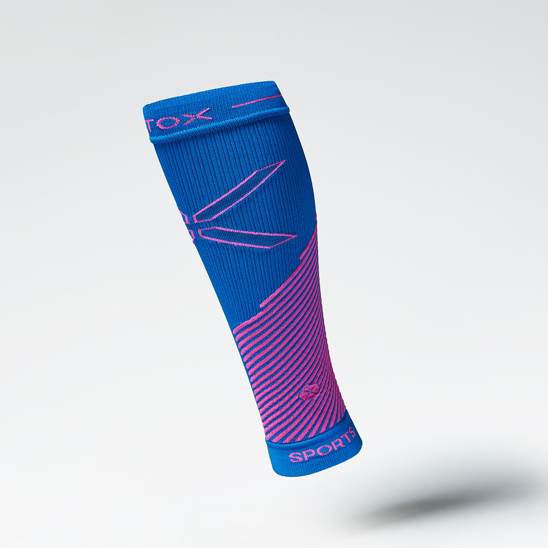 Front view of a blue compression calf sleeve with pink details. 