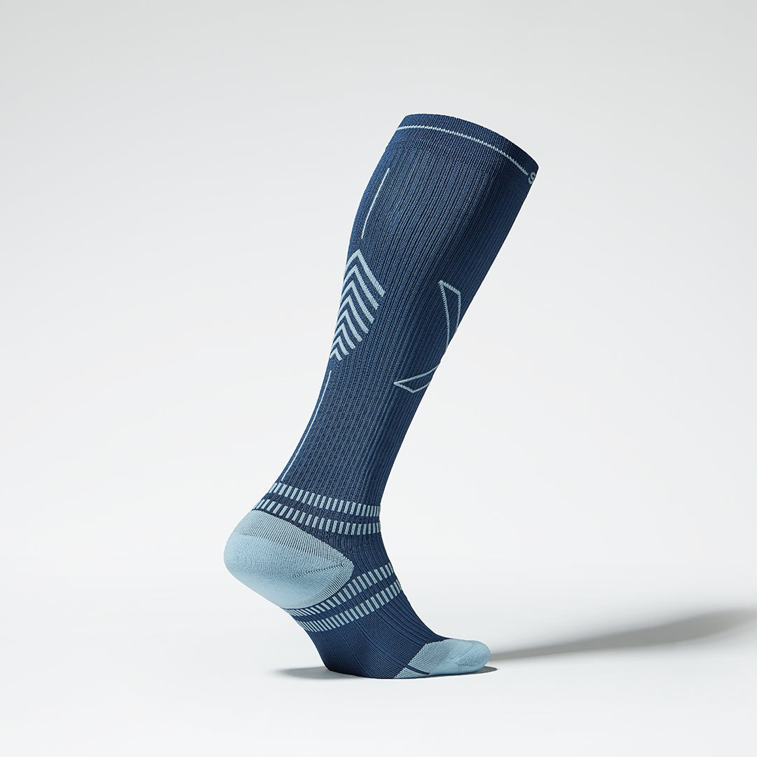 The side of a knee high compression sock in blue with grey details.