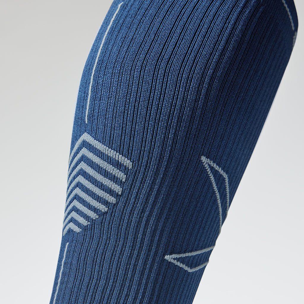Close up of a blue compression sock with grey lines.