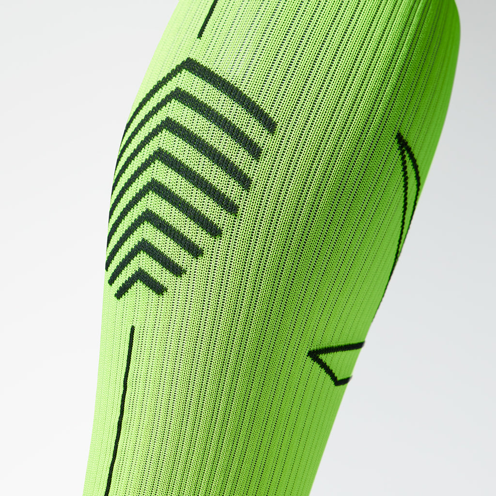 Detailed view of a fluo yellow compression sock with black details.