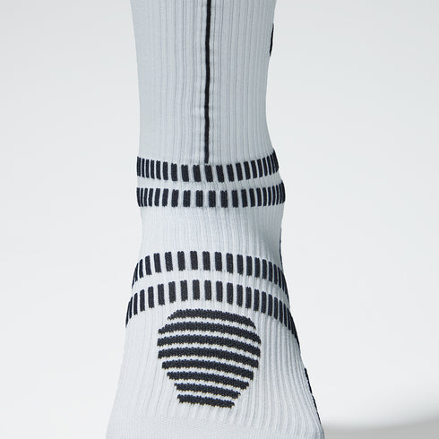 White compression sock zoomed in with black accents.