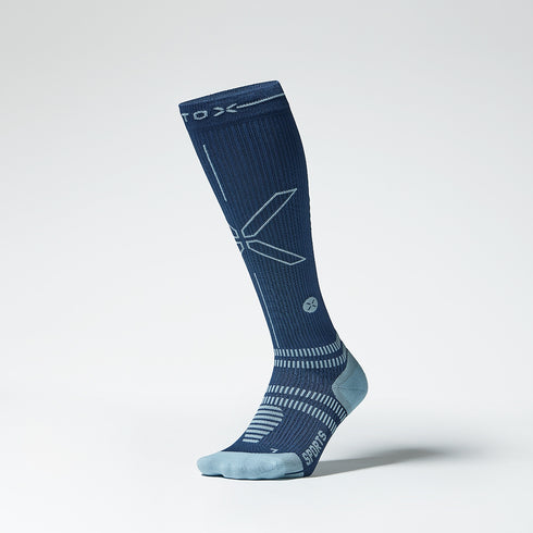 The front of a knee high compression sock in blue with grey accents.