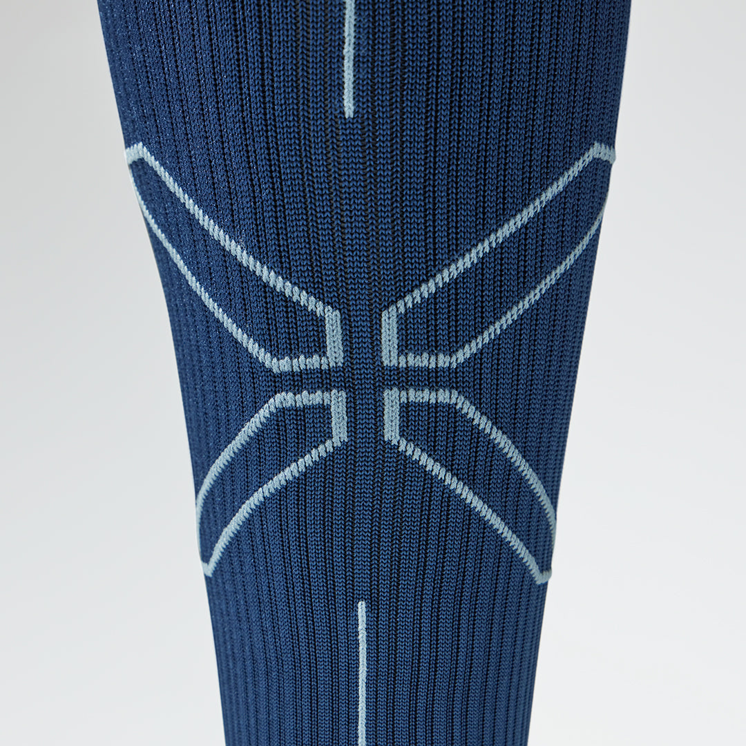 Close up of a blue compression sock with a grey logo.
