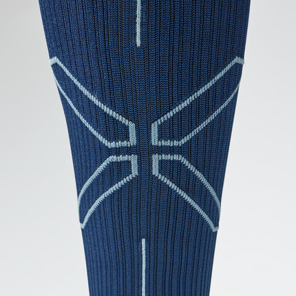 Close up of a blue compression sock with a grey logo.