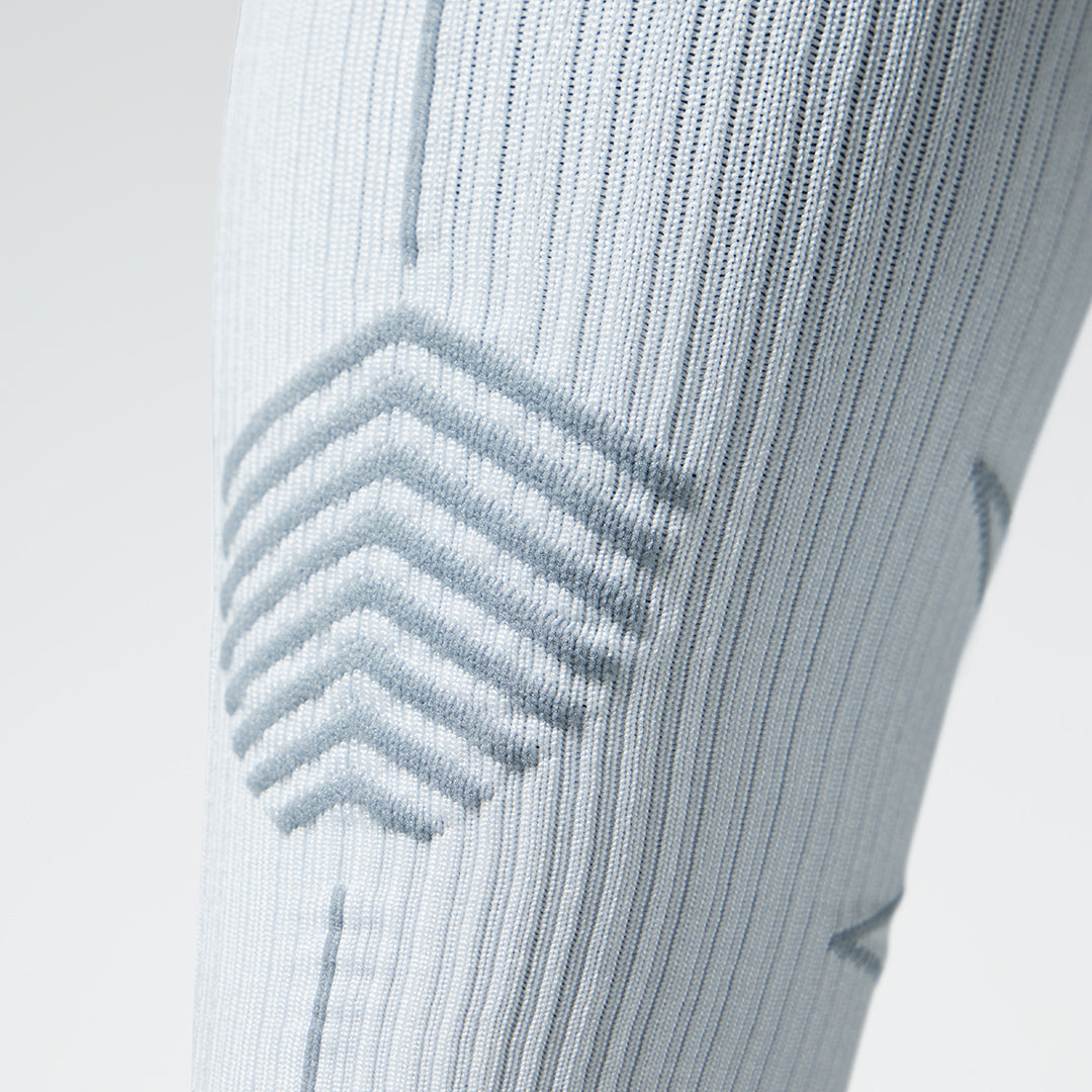 Close up of a white colored compression sock with grey accents.