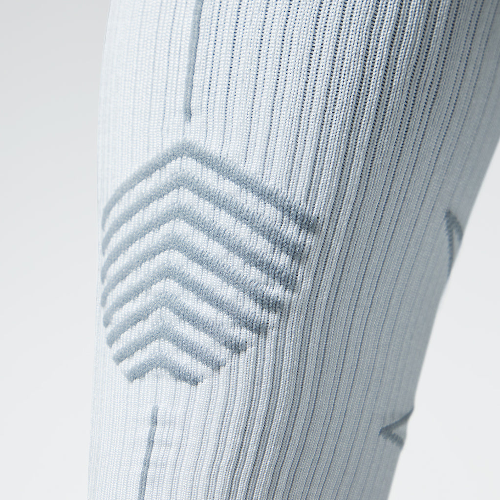 Close up of a white colored compression sock with grey accents.