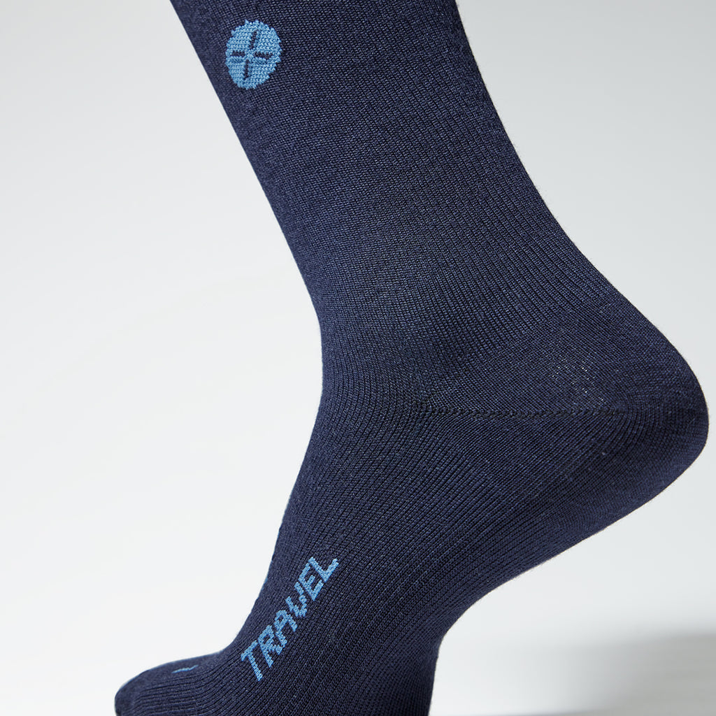 Detailed view of a blue knee high travel compression sock with blue details.
