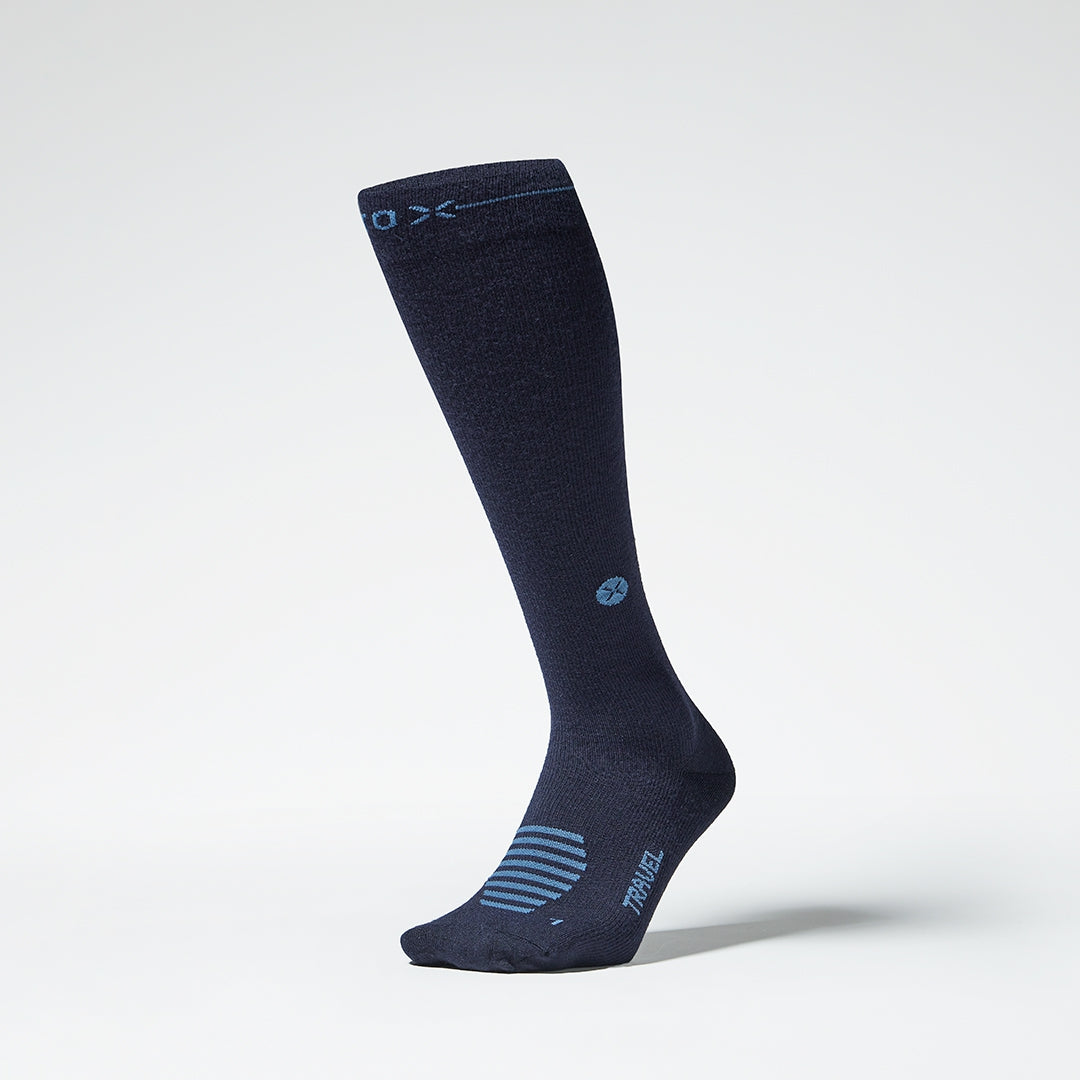 Front view of a blue knee high compression sock with blue details.