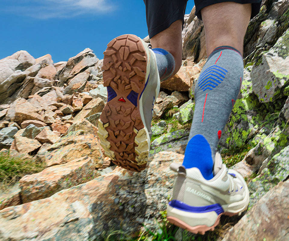 Man hiking over rocks.