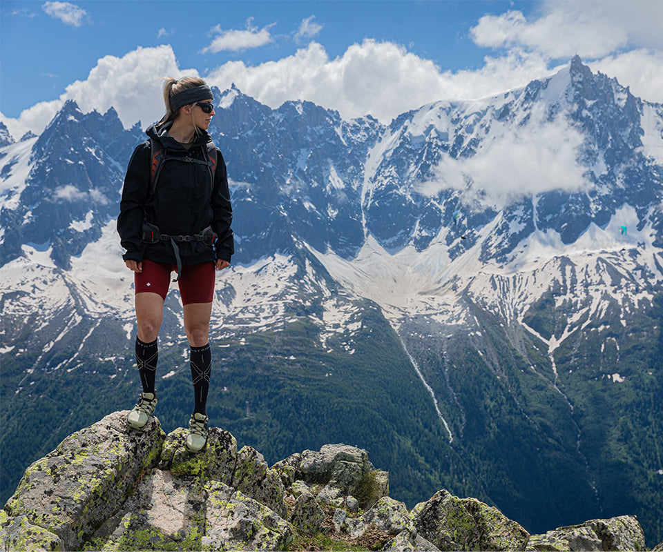 Woman standing on a rock, looking the other way.