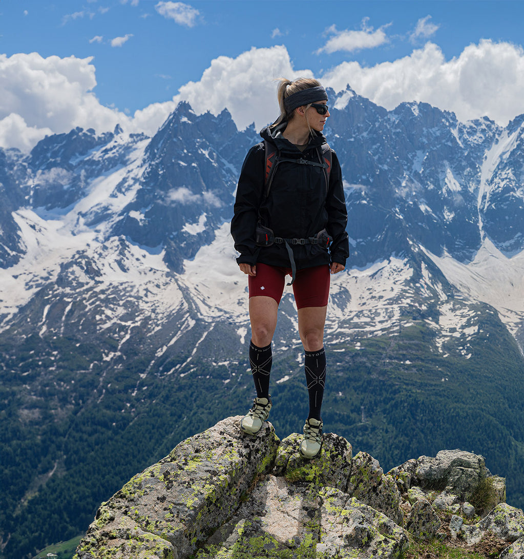 Woman standing on a rock, looking the other way.