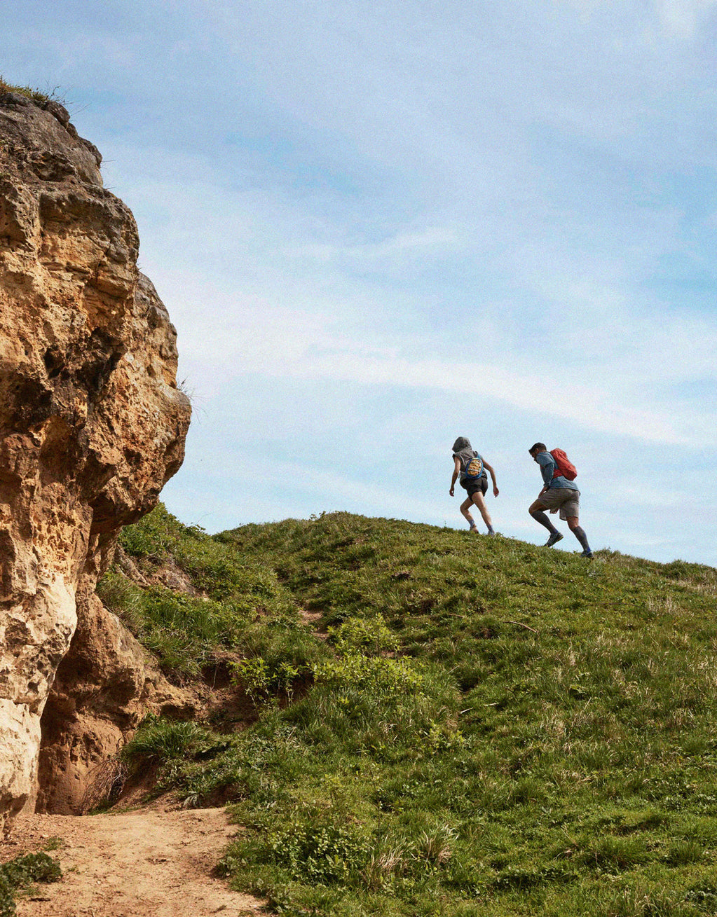 Couple walking up a hill.